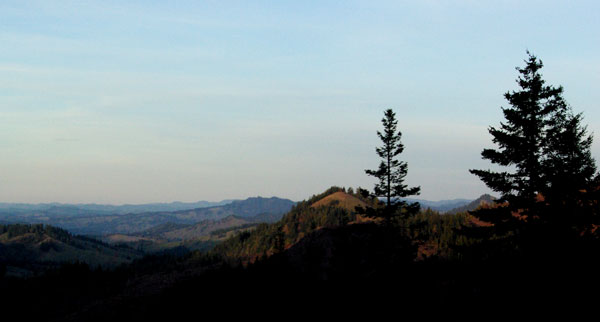 sun setting across the valley